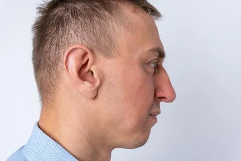 Man presenting his profile, displaying side view of his face and ear agains.. Stock Photos