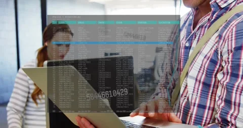 Man presenting laptop, typing in open-plan office, activating terminal overlay Stock Footage 333829942