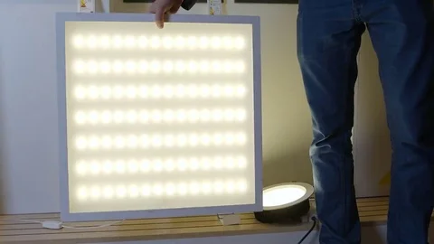 Man presenting LED panel lamp Stock Footage 69166537