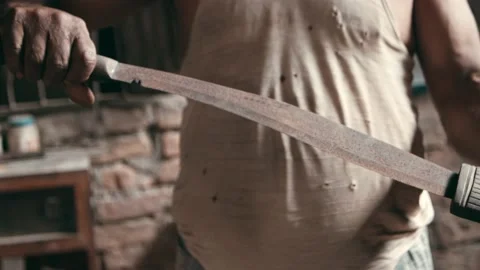 Man presenting old rusty kukri knife in wooden sheath Stock Footage 164844059