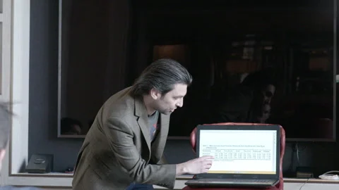 Man Presenting Research Findings on Laptop to Audience Stock Footage 343972907