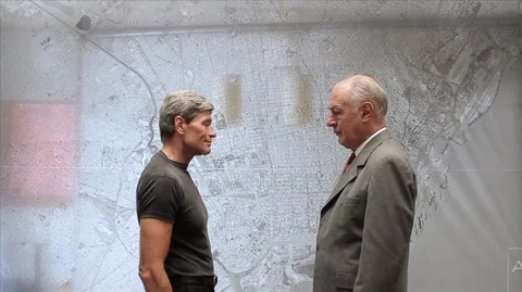 Man presenting rolled documents/building plans to a businessman and then shaking 스톡 동영상 88407111