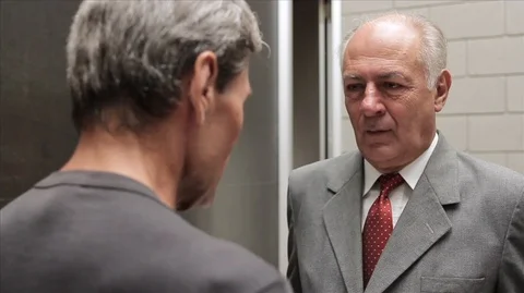 Man presenting rolled documents/building plans to a businessman and then shaking Vídeos de archivo 88438241