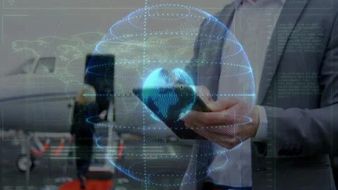 Man presenting smartphone in hangar animating globe with orbiting rings and data Stock Footage 330192400