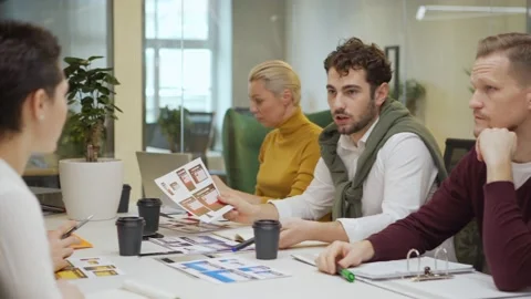 Man presenting website templates in team meeting Stock Footage 132815274