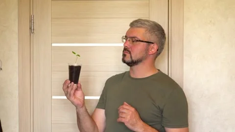 A man presents a seedling 4K Stock Footage 274402651