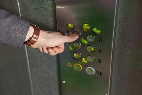 Man press button in elevator with germs, closeup Foto stock