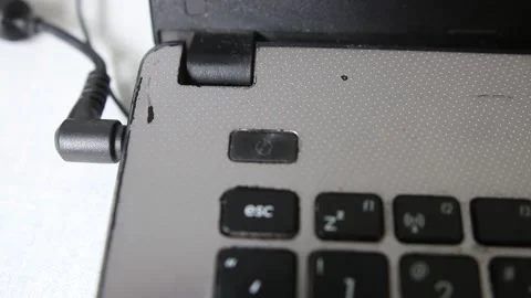 A man press a on/off button in a heavily laptop computer  Stock Footage 229809418