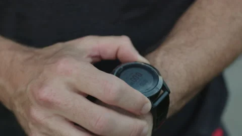 Man press button on sport watch 動画素材 130760911