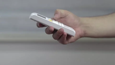 Man Press Buttons And Turning On Air Conditioner With Remote Control Stock Footage 233858684