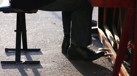 Man press foot pandel while Playing the Piano Stock Footage 56196172