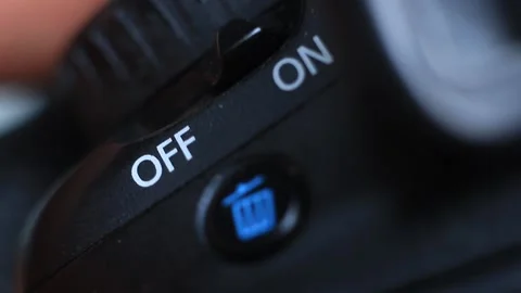 A man press a on/off switch in a digital camera with a delete/trash can buton ve Stock-Footage 225088788