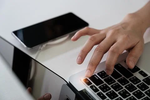Man press turn off button laptop computer and turn off smartphone Social media Stock Photos