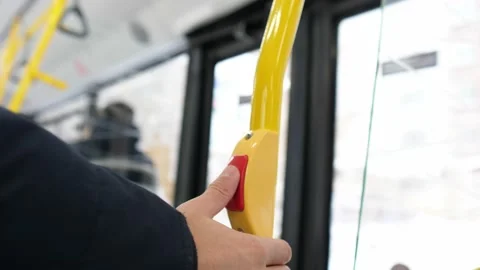 Man presses bus stop bell on the bus in slow motion. Red stop transport button Vídeos de archivo 165537569