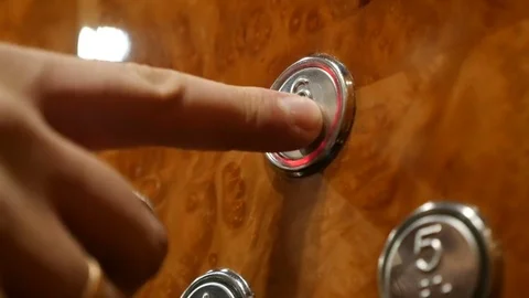 The man presses the button 6 floor in the elevator Видео 83095740