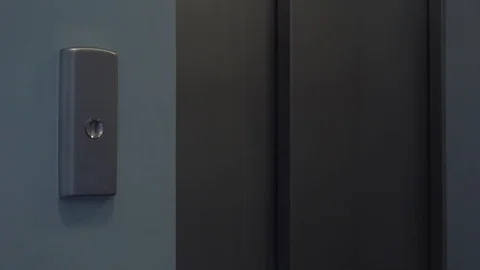 A man presses a button and an elevator door slides open - closeup Video stock 82233856