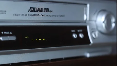 A man presses a button and rewinds an old cassette. Stock Footage 125513869