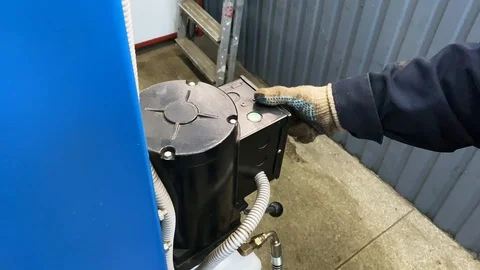 Man presses a button on a car lift Stock Footage 125006293