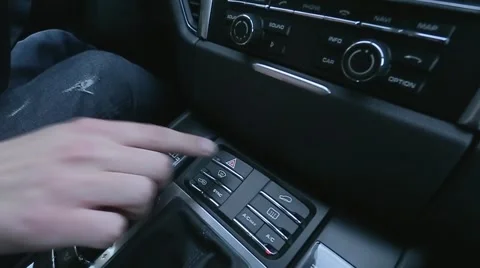 Man presses button on car's dashboard Stock Footage 63145935