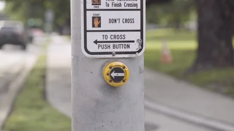 A man presses a button to cross at the crosswalk Stock Footage 108757587
