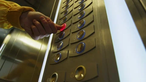 A man presses a button in the elevator Stock Footage 236897518