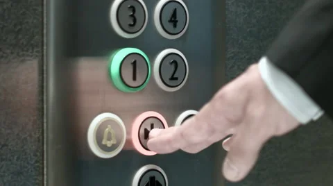 Man presses a button the first floor and a button closing elevator doors Video stock 51458323