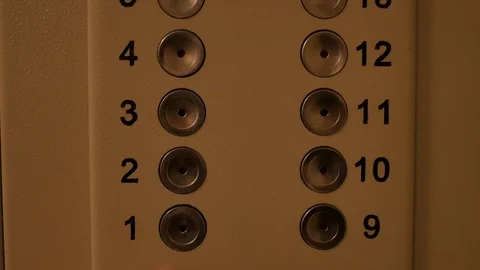 A man presses a button on the first floor in an old Elevator. Stock Footage 125697426