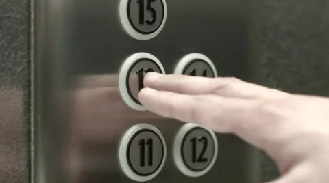 Man presses a button the thirteenth floor in an elevator Vidéo 51468985
