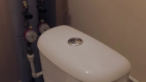  man presses the button on the toilet cistern Stock Footage 102958158