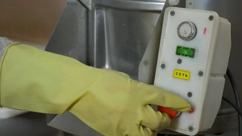 The man presses the button to turn on the potato cleaner Stock Footage 89609150