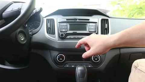 Man presses the buttons on the control panel in the car. Vídeo Stock 139496173