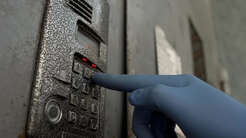A man presses the buttons in the intercom in medical gloves. The concept of 스톡 동영상 127445718