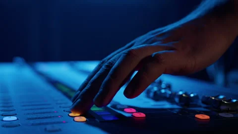 A man presses the buttons of the sound controller while setting up the equipment Stock Footage 241220112