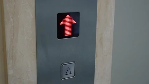 Man presses elevator up button, elevator doors open and he goes inside Stock Footage 220007636