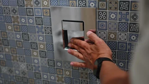 Man presses fingers on flush button on wall. Man presses flush panel with hand Video stock 326215843