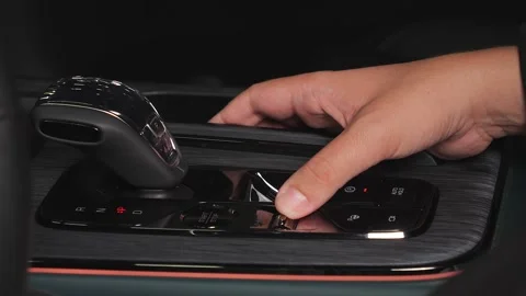 A man presses his hand on various buttons in a car Stock Footage 278861395