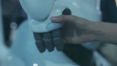 The man presses a plastic mechanical arm to the robot Stock Footage 90839136