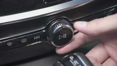 Man presses play button and increase volume of multimedia in car. closeup view Stock Footage 147119590