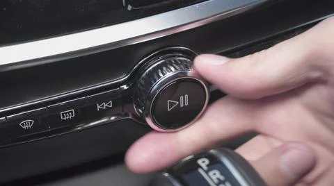 Man presses play button and increase volume of multimedia in car. closeup view Stock Photos