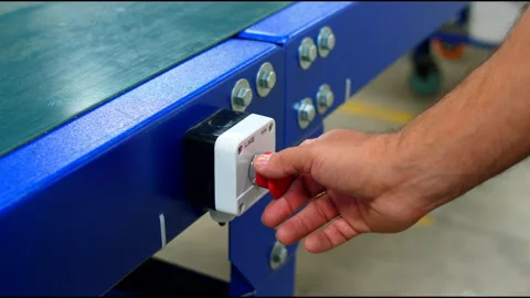 Man presses red button of conveyor belt Stock Footage 231540452