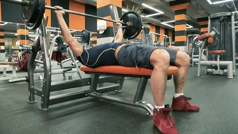 The man presses the rod lying down. Stock Footage 80438015