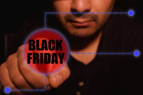 Man presses start button for Black Friday Stock Photos