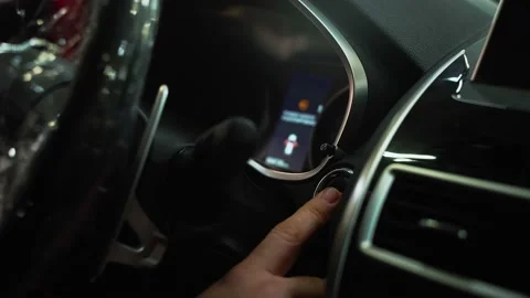 Man presses start button in car motor. Turning on functioning systems vehicle 動画素材 154845736
