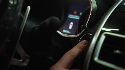 Man presses start button in car motor. Turning on functioning systems vehicle 動画素材 154931686