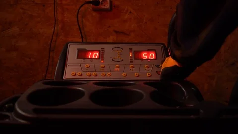 The man presses the start button on the machine to balance the tires Stock Footage 126509647