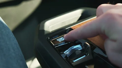 Man presses Start button on multimedia system control in car Stock Footage 178481788