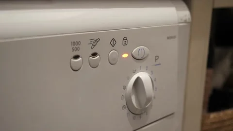 The man presses the start button on the panel of the washing machine. Stock-Footage 145425429