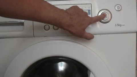 The man presses the start button of washing. Stock Footage