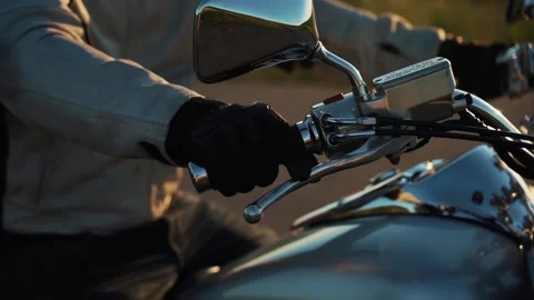 Man presses the start engine button on handlebar, oldscool bike or custom bi Stock Footage 197588785