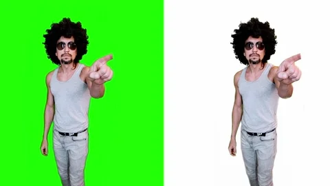A man presses virtual buttons, turns on the light, on a green background Video stock 303139863